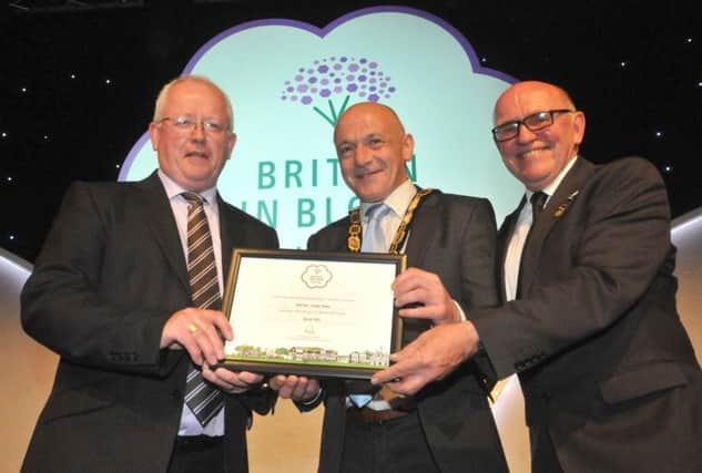 Deputy Mayor of Antrim and Newtownabbey, Councillor John Blair along with Chairman of the Operations Committee, Alderman John Smyth are presented with the RHS Britain in Bloom Silver Gilt Award for Antrim Town by Jon Wheatley, Vice Chairman of the RHS Britain in Bloom UK Judges Panel.