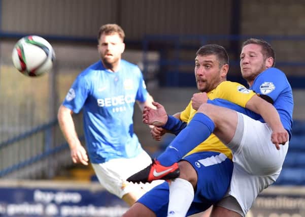 Glenavon's Kris Lindsay and Ballymena United's Matthew Tipton tussle for possession in today's game at Mourneview Park. Picture: Press Eye.