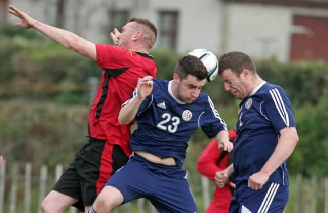 TWO HEADS ARE BETTER THAN ONE. Action from Riada FC's resounding win over Gilford on Saturday.INBM43-15 031SC.