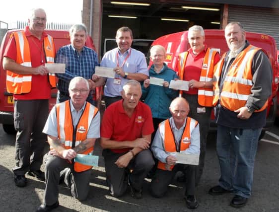 POSTEMEN DELIVER. Manager Ian Dunseith along with local postmen hand over six cheques totalling £3,206.00 to Mervyn Ferris and Dorothy Hill from Cancer Research UK on Friday. The money was raised through the annual Van Pull and other events.INBM43-15 012SC.