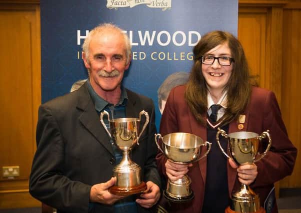 Emma Rose Collins who received the 'Lady Bloomfield Cup' for outstanding achievement. She is pictured with her grandfather. INNT 43-809CON