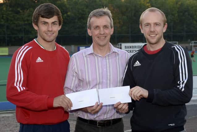 Banbridge District Sports Association Chairman Michael Watt presented the Sports Achievers of the Month for August to Banbridge Hockey Clubs' European Championships Bronze Medalists Matthew Bell and Eugene Magee ©Edward Byrne Photography INBL1540-222EB