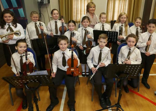 Buick Primary School orchestra who performed at the school's Harvest Service are seen here with teacher Mrs McCleery. INBT 44-102JC