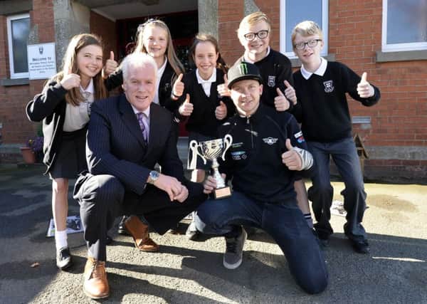 Jordanstown racer Andy Reid at his old school, Whiteabbey Primary with principal, Peter Wright. Also pictured are P7 pupils Arianna Vance, Lara Bryans, Max Wylie, Lowell Finlay and Lucy McKnight. INLT 43-915-CON