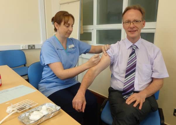 Dr Richard Wright gets flu vaccination.