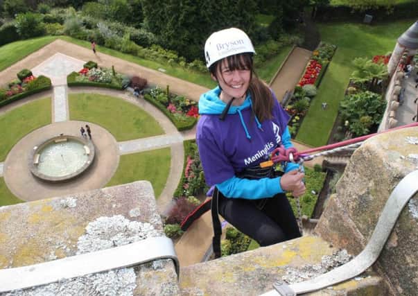 Good head for heights: Rachel Kerr taking part in the abseil challenge for the Meningitis Research Foundation at Belfast Castle. INNT 43-830CON