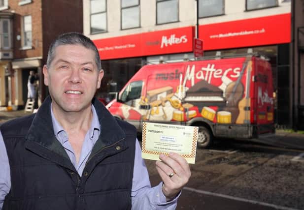 Music Matters owner Stephen McLoughlin with the parking ticket he received.