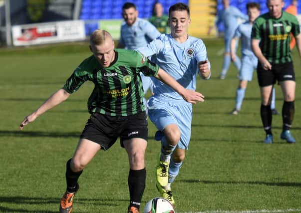 Donegal Celtic defender Mark Shannon holds off Institute's Gareth Brown. INLS4315-141KM
