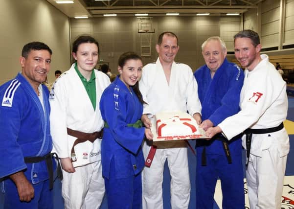 Jim Toland, third from right, pictured with fellow St. Columb's Park Judo Club coaches, from left, Tawfiq Azennoud, Kirstie Strouts-McCallion, Kate Martin, Robbie Irwin and Paul McGarrigle, when he was presented with a special cake to celebrate his achievement in gaining his 6th Dan belt. INLS4315-152KM