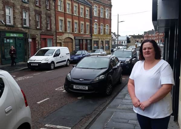 Mid Ulster SDLP Councillor for Dungannon, Denise Mullen, illustrates the differences in the disabled bays on either side of Irish Street in the town.