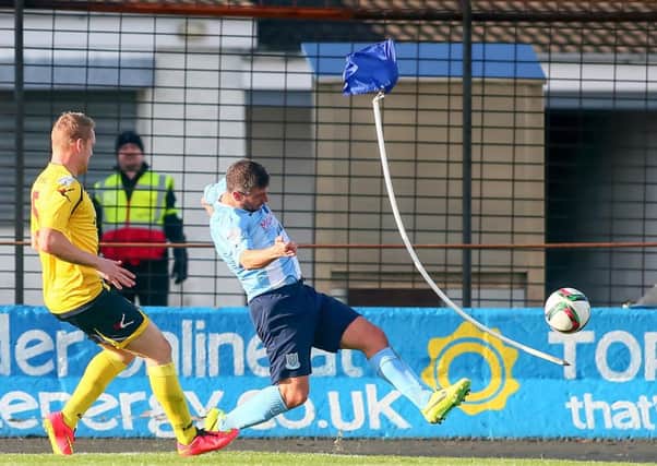 Ballymena United striker Matthew Tipton - who was later sent off - kicks the corner flag as he attempts to cross the ball during today's Danske Bank Premiership game against Dungannon Swifts. Picture: Press Eye.