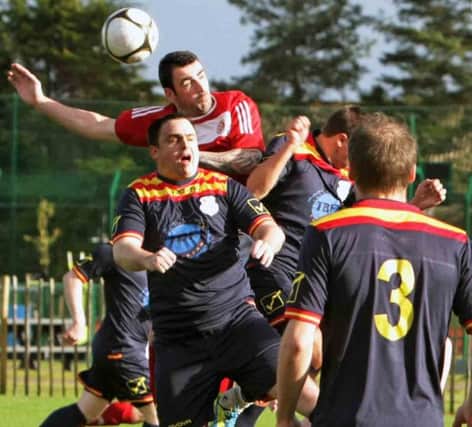 UP FOR IT. Action from Riada FC's 3-1 win over Garvagh at Megaw Pk on Saturday.INBM44-15 031SC.