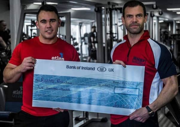 Mark Foster (left) Manager of Atlas Gym, Coleraine presents a sponsorship cheque to Richard Robinson for the World Championships