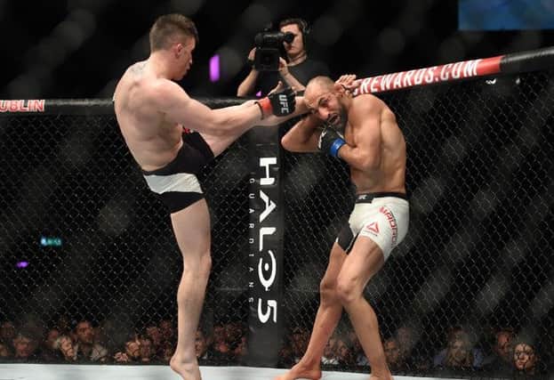 Norman Parke (red gloves) competes against Reza Madadi (blue gloves) during UFC Fight Night