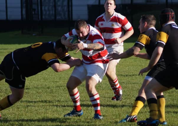 A Randalstown Third XV player comes under pressure from a Cookstown opponent during Saturday's match. Picture: Marc Lawrence.