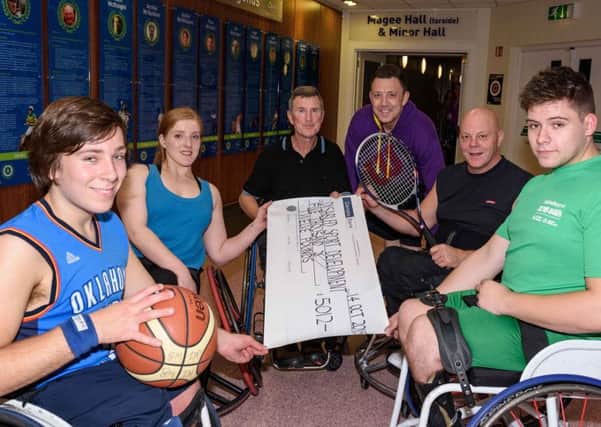 Ulster Hand Cycling Association member Ivor Jess (centre)  presents a cheque for £5012 in aid of Disabled Sport Development to Knights Junior Basketball team members Jason Kennedy, Eimear MacSorley and Luke Marshall, to Stafford Lynn of Spokes in Motion Wheelchair Tennis Club, and to Jack Agnew of All Torque Trackchair Racing Club at the Antrim Forum. INBT 44-170CS