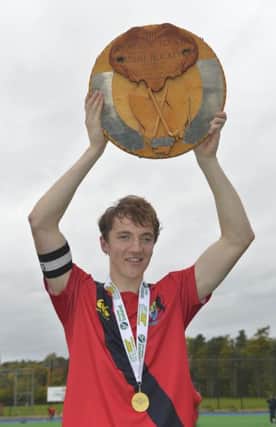 Banbridge captain Andrew Bennington with the Tasmanian Trophy. Pic: Rowland White / Presseye