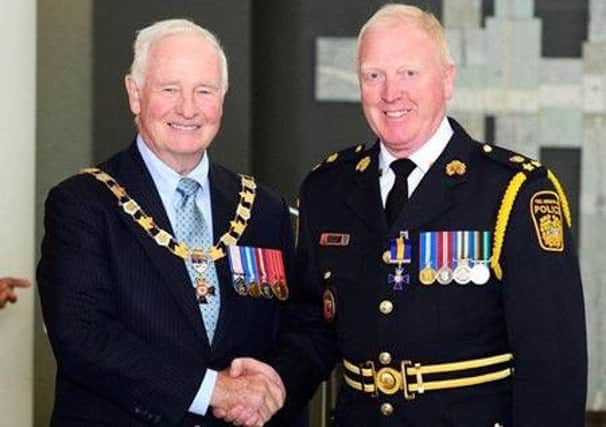 Deputy Chief McCord (right) and Governor General David Johnston during a ceremony at the Citadelle of Québec where McCord was invested as a Member of the Order of Merit of the Police Forces. INLT-43-716-con