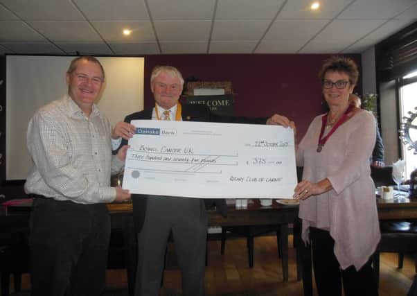 L-R Norman Surplus Vice President of Larne Rotary Club John Shannon and Hazel Bell with the £375 cheque for Bowel Cancer which Norman raised by giving a talk on his gyrocopter adventures. INLT-43-717-con