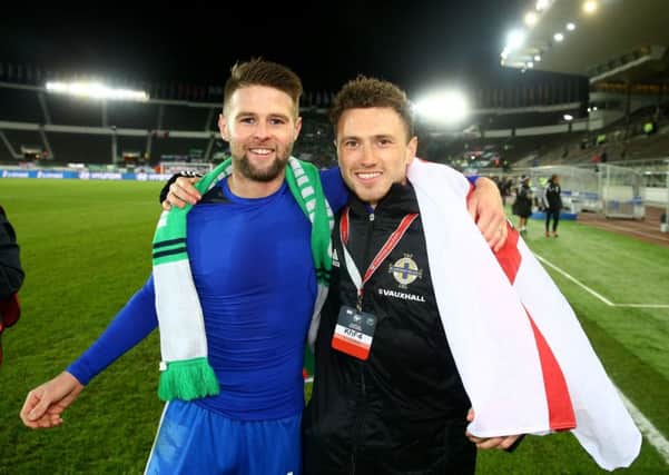 Northern Ireland's Oliver Norwood and Corry Evans celebrate after the 1-1 draw in Finland secured the team top spot in UEFA Euro 2016 Qualifying Group F. Pic by William Cherry, Press Eye