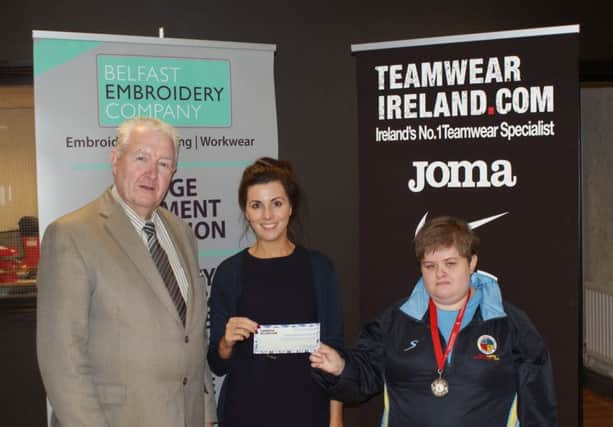 Jimmy Walker, Chairman of Sport Lisburn & Castlereagh Committee and Teamwear Ireland representative Nicola Branagh congratulates badminton star Abbey Fusco on winning the Sports Personality of the Month Award for August.