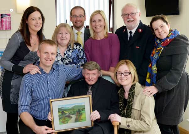 Ivan Parry, a patient of the Southern Health and Social Care Trusts Neurology service has donated one of his own paintings as a thank you to the staff for their top quality service. (Top row) Fiona Patterson, Mrs Parry, Martin Stevenson, Dr Karen Doherty, Roland Sewell, Caroline McEvoy(Lower row) Dr Raeburn Forbes, Ivan Parry, Sharon McGinn