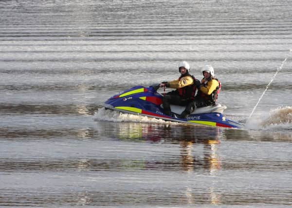 Members of the Foyle Search and Rescue team on one of their jet skis. 1703JM30