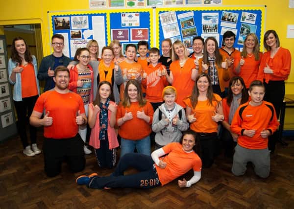 Some of the teachers and pupils dressed in orange for Myeloma UK.   INCT 45-721-CON