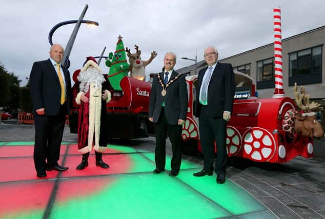 Pictured at the launch of the Christmas Switch On that will take place in Market Square, Lisburn on the 19th November  are: (l-r) Alderman James Tinsley, Chairman Of Council's Corprate Services Committee; Santa Claus;  the Mayor, Councillor Thomas Beckett and Alderman Allan Ewart, Chairman of the Council's Development Committee.