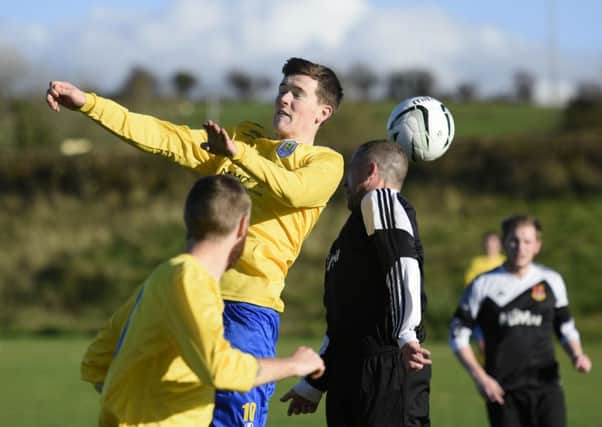 Cormac Quigley, Roe Valley Reserves, and Mark Robb, Foyle Wanderers Reserves, contest this high ball. INLS4415-121KM