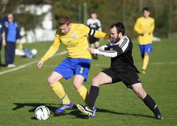 Gary Brady, Roe Valley Reserves, and James McCracken, Foyle Wanderers Reserves, tussle for the ball. INLS4415-120KM