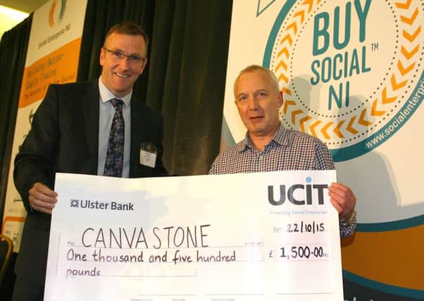 Frazer McCammond (right) of Dromore Social Enterprise 'CanvasStone' receiving a cheque from Phelim Sharvin, Associate Director UCIT.