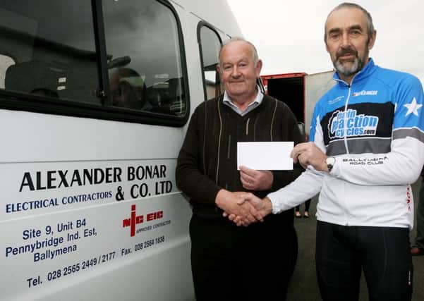 Alex McAuley, from Alexander Bonar & Co. Ltd, presents a sponsorship cheque to Pius McKernan of Ballymena Road Club. INBT39-215AC