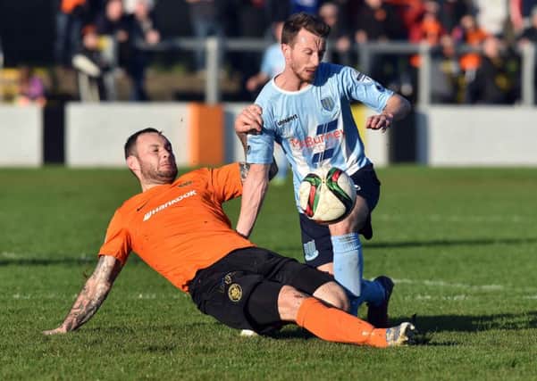 Carrick's Andrew Doyle
 and Ballymena's William Faulkner 
during Saturday's match at the Belfast Loughshore Hotel Arena. 
Photo by TONY HENDRON/Presseye.com.