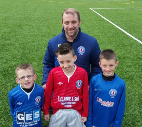 Former Banbridge Rangers striker Peter Gilchrist with his three sons Matthew, Dylan and Billy who all scored on Saturday for the club's junior sides.