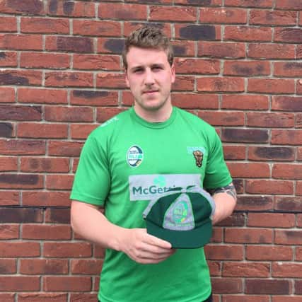 Clark shows off the first Ireland cap he won over the summer.