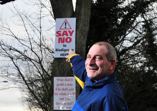 Ballynakelly resident Trevor Stratton points to the "Say No to the Biodigester Plant Here" sign. INTT5014-329