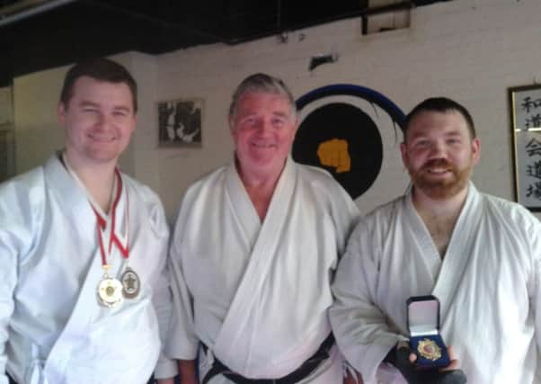 Oliver Brunton Jnr who took silver and bronze medals at the Northern Ireland Karate Championships; his father Oliver Brunton Snr and bronze medalist Tommy Little.