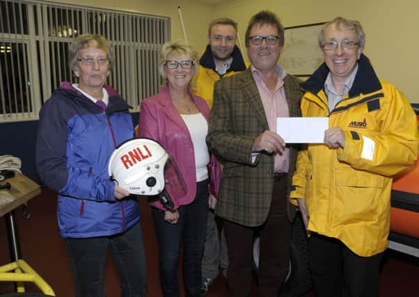 Local businessman Jackie McIlwaine recently celebrated his 70th Birthday with a party at his home where he raised £1,000 in lieu of presents.  He and his wife Audrey are pictured here presenting a £1,000 cheque to Stephen Craig, chairperson of Larne RNLI Fundraisers.  Also pictured are fundraising secretary, Esther Dorman and crew member, Lee Stirling. INLT 44-200-AM