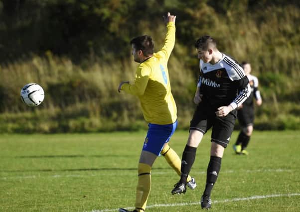 Lee Kelly, Foyle Wanderers Reserves, and Jamie Vinnicombe, Roe Valley Reserves, tussle for the ball. INLS4415-125KM