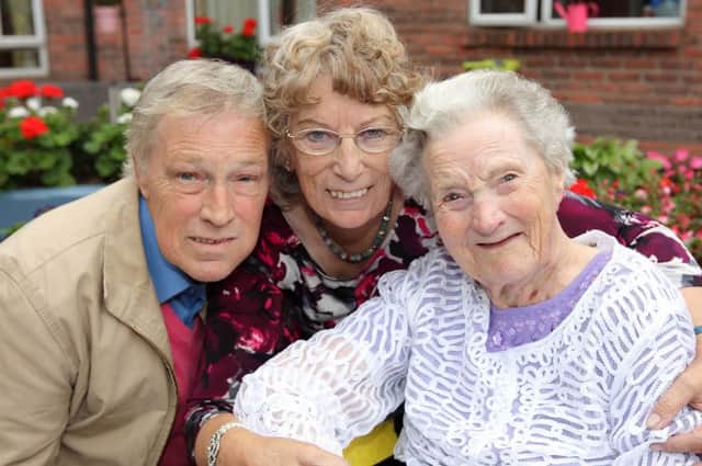 David Henning and Winfred Thompson helping their mother Ruth Henning, right, a resident at Rosevale Care Home on the Moira Road, celebrate her 102nd birthday. US1438-534cd  Picture: Cliff Donaldson