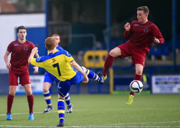 Bangor midfielder Andy Long tackles Institute's Aaron Harkin during Saturday's game. Picture by Kevin Scott/Presseye