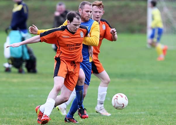 Roe Rovers Tommy Hassan in the thick of the action against Eglinton on Saturday. INLV4615-625KDR