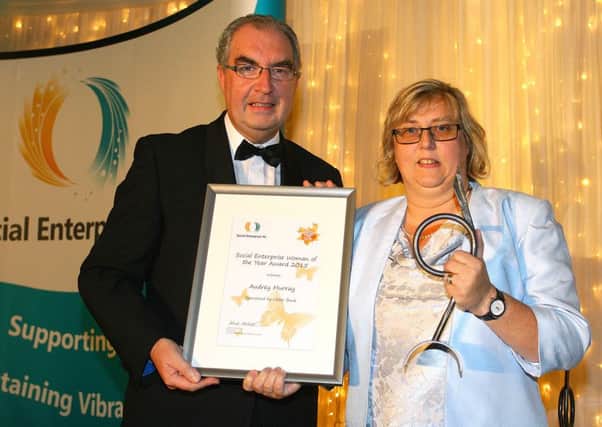 Audrey Murray receives her Social Enterprise Woman of the Year award from Colin Jess, Ulster Banks Head of Not for Profit SME Banking, at the Northern Ireland Social Enterprise Awards. INNT 46-518CON