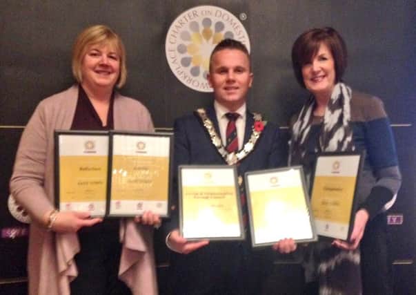 Mayor of Antrim and Newtownabbey Councillor Thomas Hogg, Councillor Linda Clarke, Chairman of Antrim and Newtownabbey PCSP and Councillor Noreen McClelland pictured at the recent ONUS Awards in Newry. The Mayor collected 'Safe Town' awards for Antrim, Ballyclare, Glengormley and Whiteabbey. Antrim and Newtownabbey Borough Council also received a 'Gold Award' for its workplace charter on domestic violence. INNT 46-517CON
