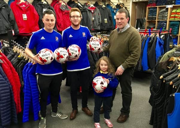 Roy Smyth, of Outdoor Adventure, and his daughter Holly present Peter Adams and Peter Thompson, of Wakehurst Strollers, with a set of five new Mitre training footballs.