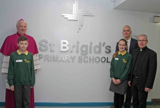 BLESS YOU. Bishop of Down & Connor Rev Noel Treanor, who blessed the extension at St Brigid's PS, pictured on Friday along with Principal Malachy Conlon, Parish Priest, Fr Francis O'Brien and Headboy and Girl, Sean and Caoimhe.INBM46-15 011SC.