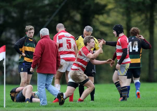 Randalstown Seconds' Matty McWhinney is congratulated by his team mates after scoring his team's second try  during Saturday's game with Lisburn. INBT 46-373cs