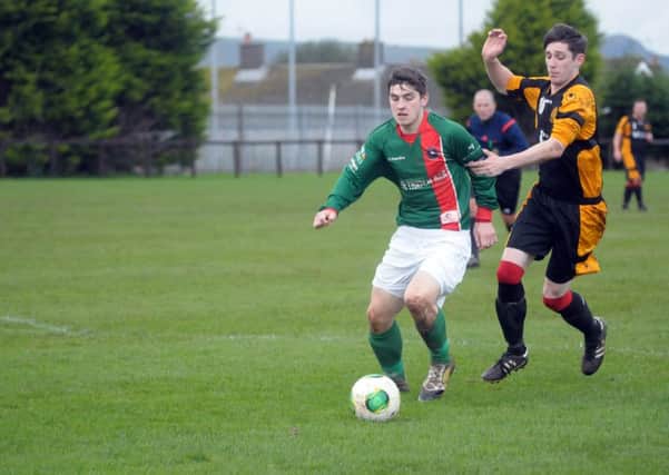 Barn's Rob Armstrong gets to grips with Larne Tech's Gary Workman in Saturday's derby clash. INLT 45-221-AM