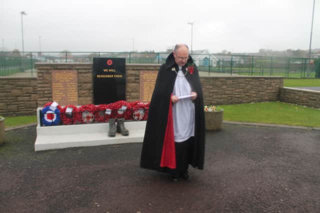 The Rev Mark Taylor reading the list of names of the fallen at Whitehead Cenotaph on Sunday. INCT 45-708-CON